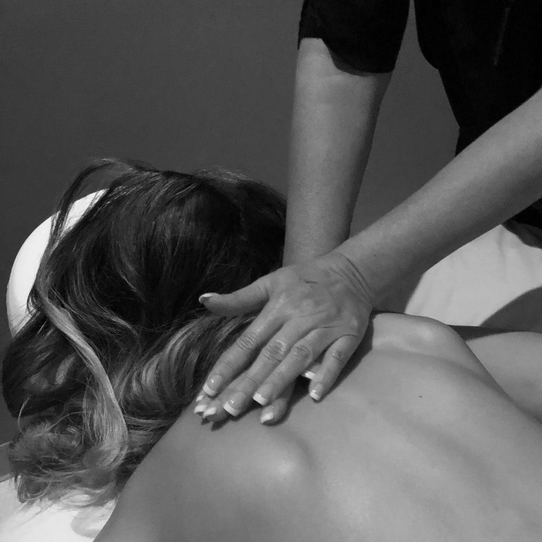 This is a picture of a massage therapist rubbing a client's upper shoulders. The photo shows only the hands and the client's upper shoulders.